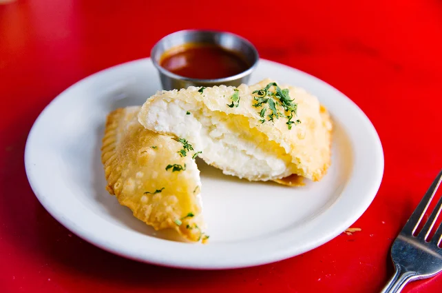 Crispy Indian samosas with tangy dipping sauce