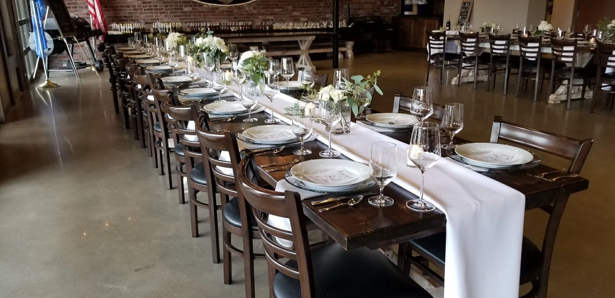 Elegant dining hall with tables set for a formal event.