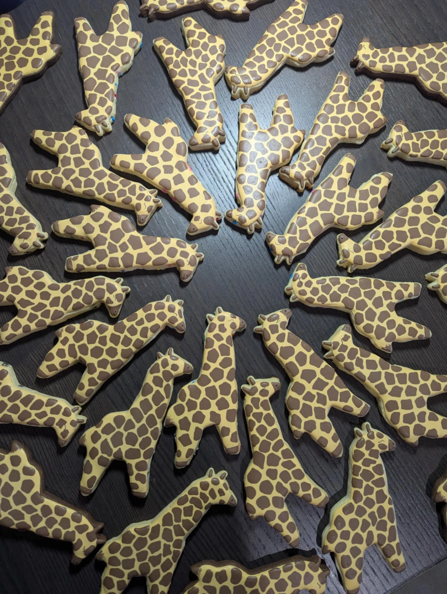 Decorative giraffe-shaped cookies arranged on a wooden table