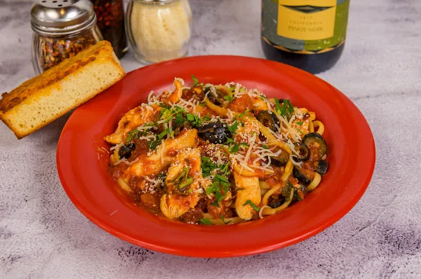 Italian chicken pasta with marinara sauce and garlic bread