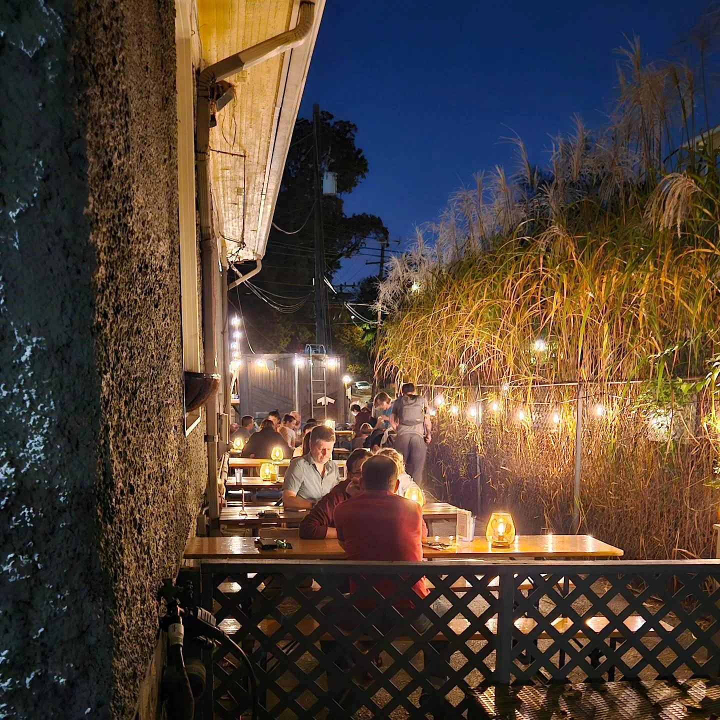 Cozy outdoor dining area with warm lights at night