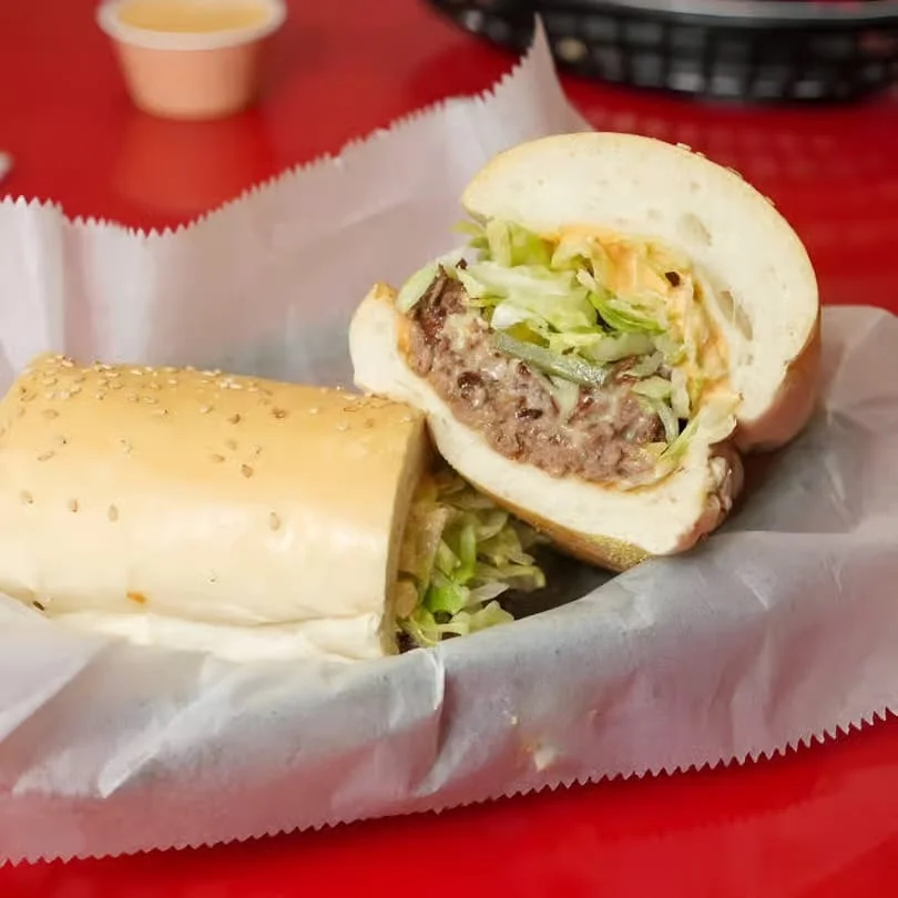 Classic American cheeseburger with lettuce in a sesame seed bun