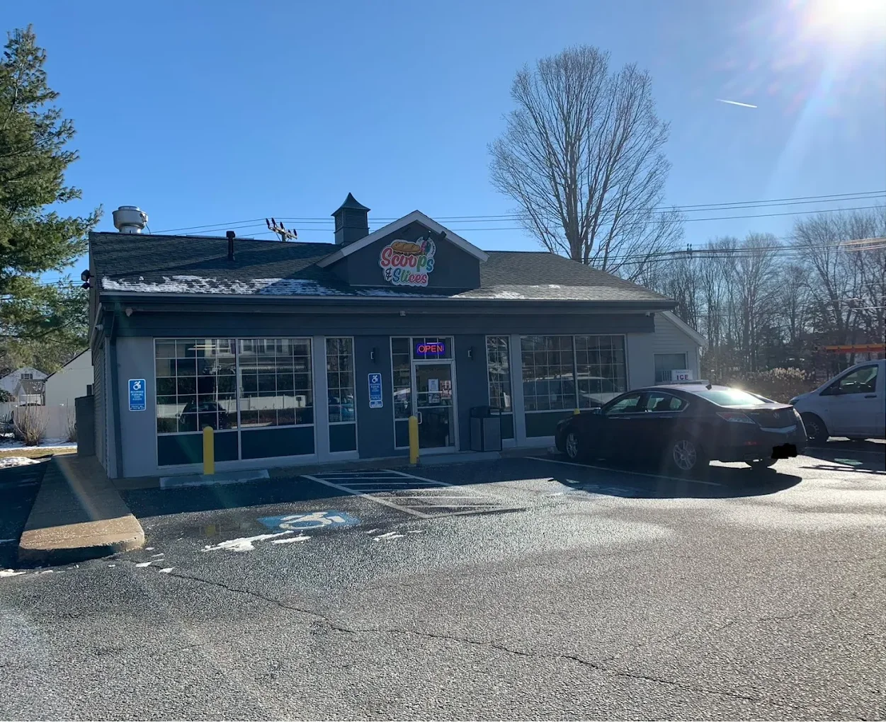 Exterior view of a cozy restaurant with a welcoming sign