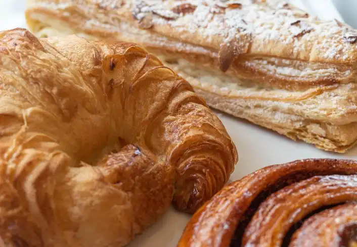 Assorted sweet and savory European style pastries, including croissants