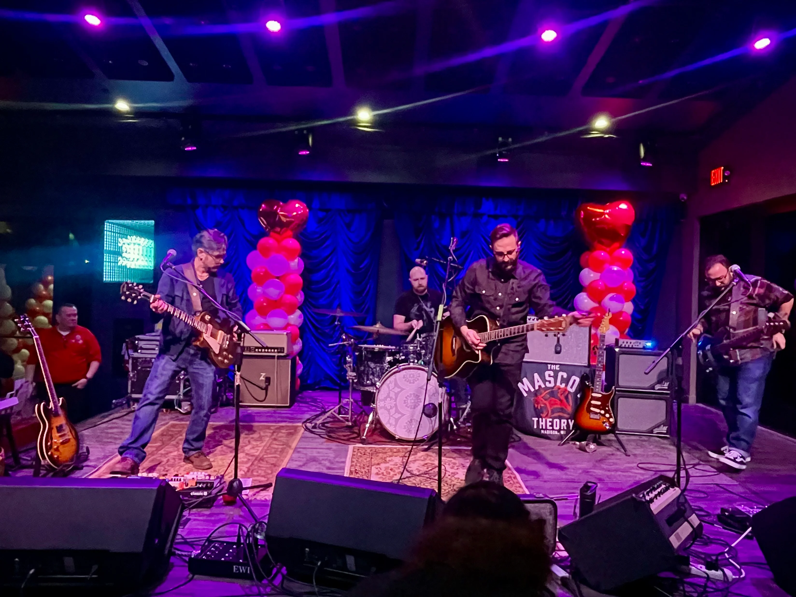 Live band performing on stage with colorful lighting