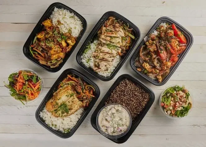 Assorted Mediterranean meal boxes with rice and grilled meats