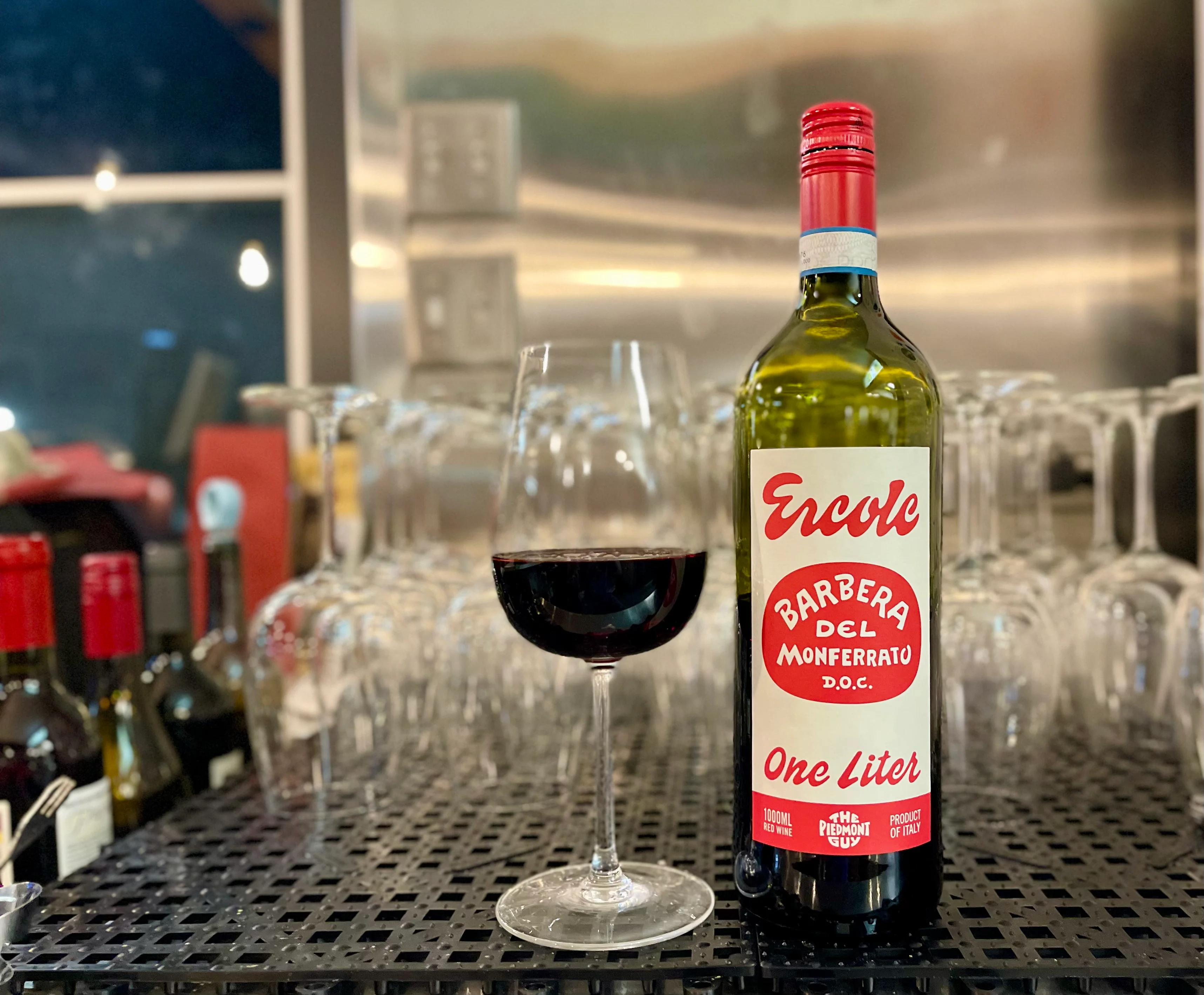 Bottle of Barbera del Monferrato wine with a glass