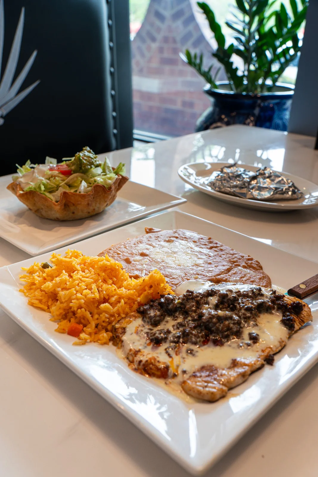 Delicious Mexican plate with chicken, rice, and salad