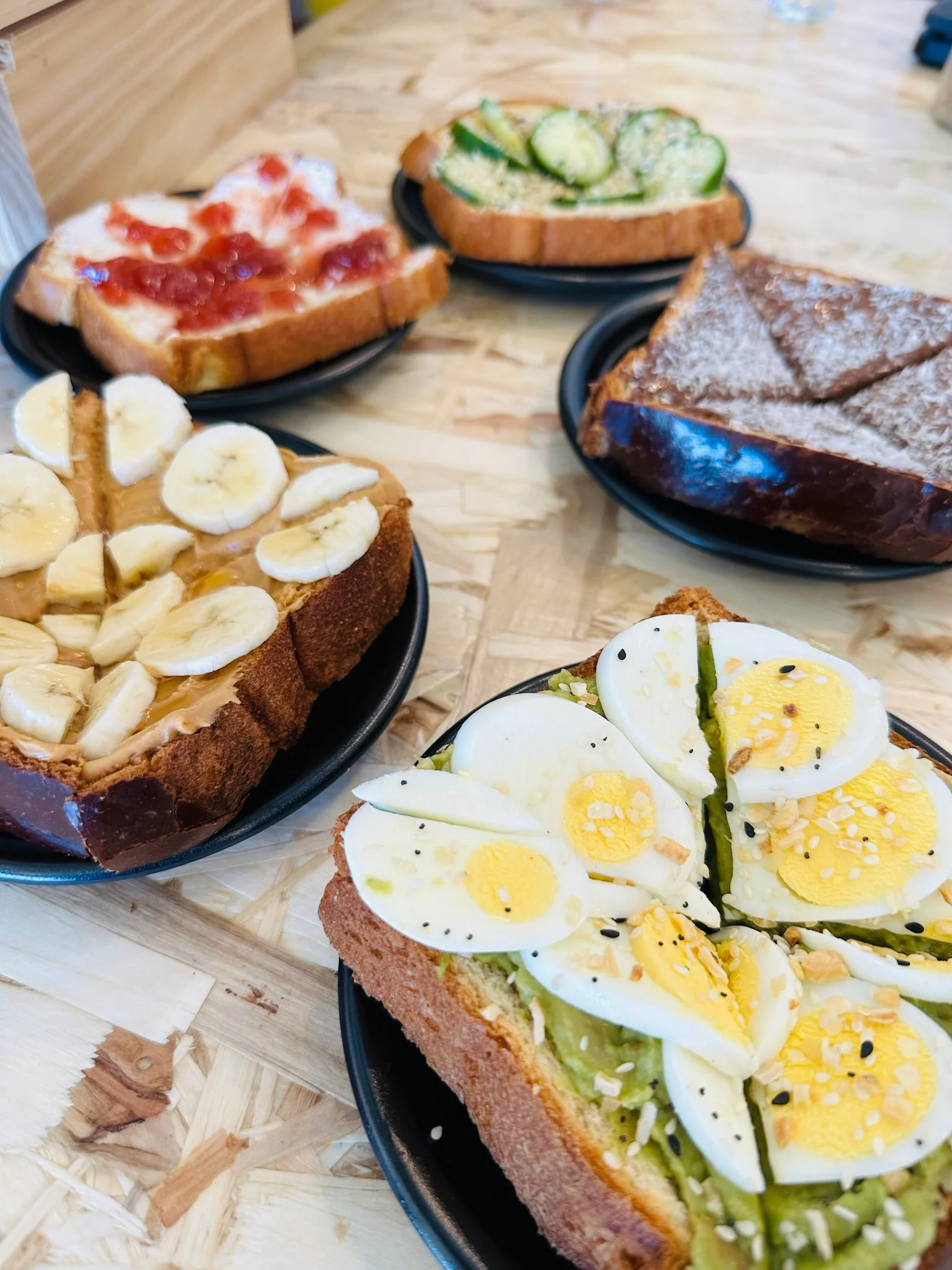 Variety of open-faced sandwiches on a wooden table