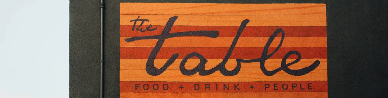 Cocktail and vibrant dishes at a cozy restaurant