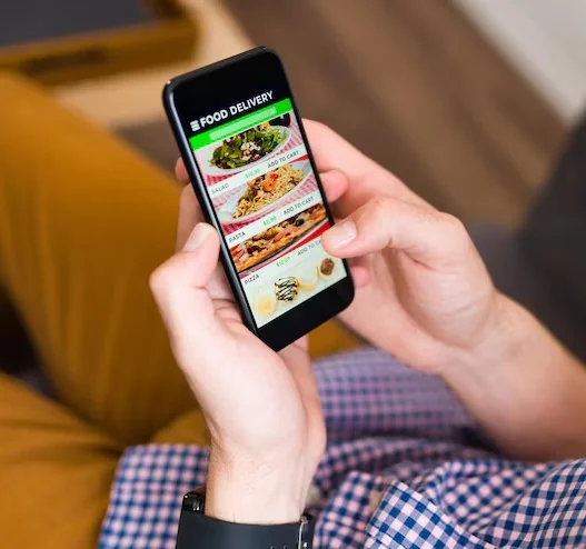 Person browsing food delivery app on smartphone