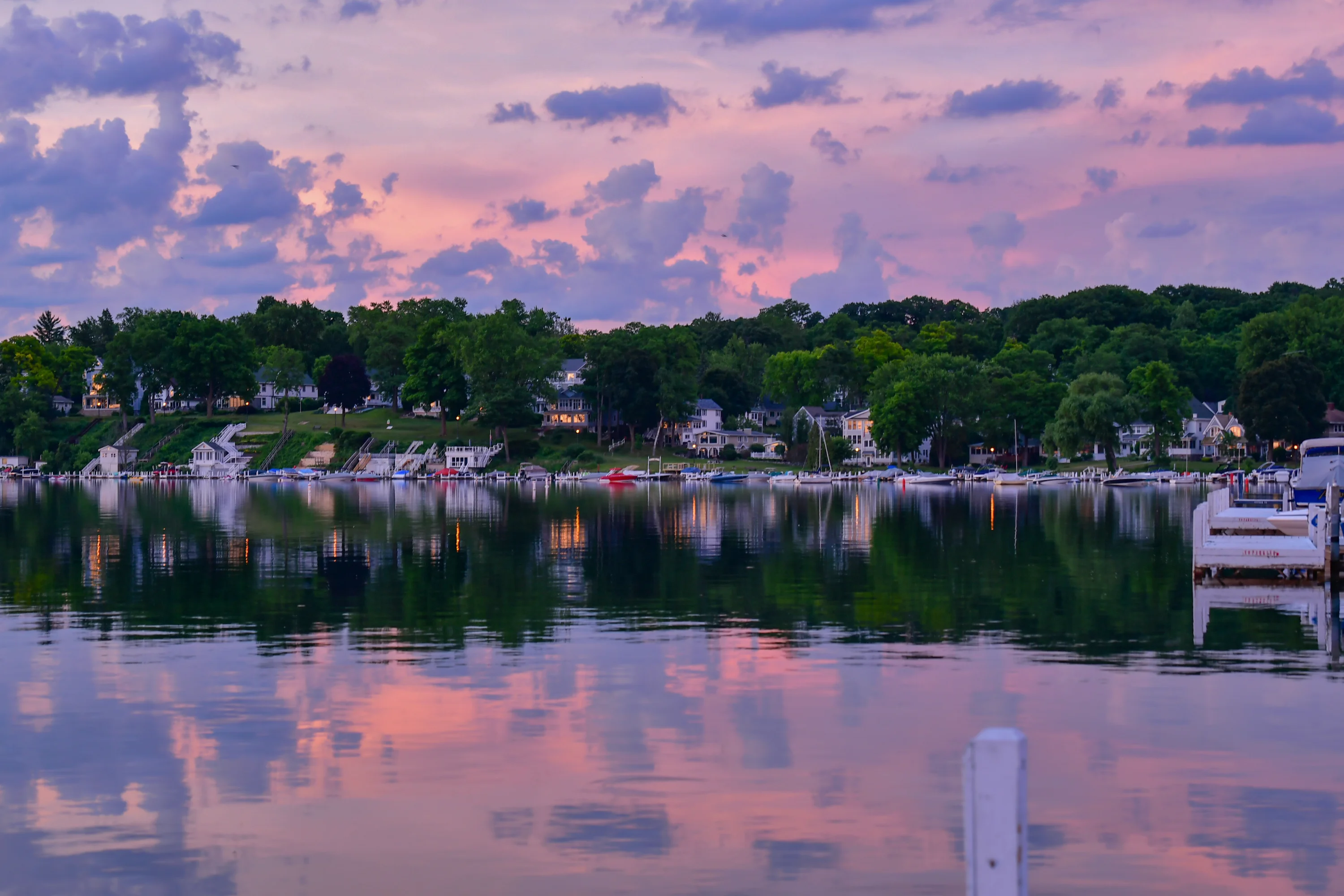 Scenic lakeside view at sunset with colorful reflections