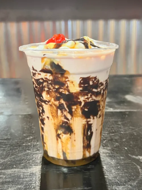 Delicious chocolate sundae with whipped cream and cherry