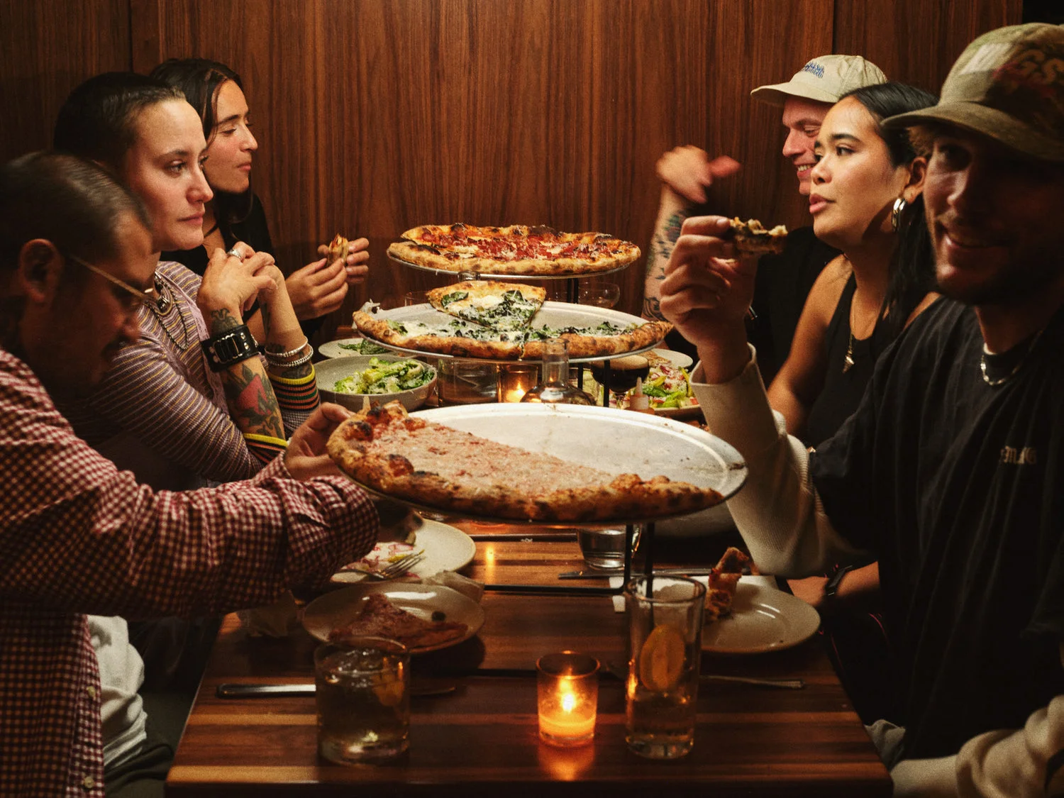 Group enjoying Margherita pizza at a cozy restaurant table