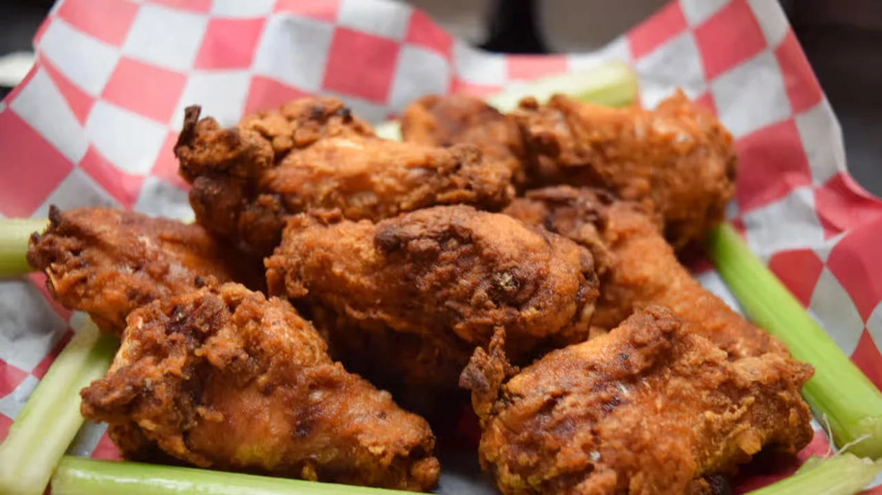 Crispy chicken wings served with fresh celery sticks at Moonlite Diner, a classic American diner favorite perfect for sharing.