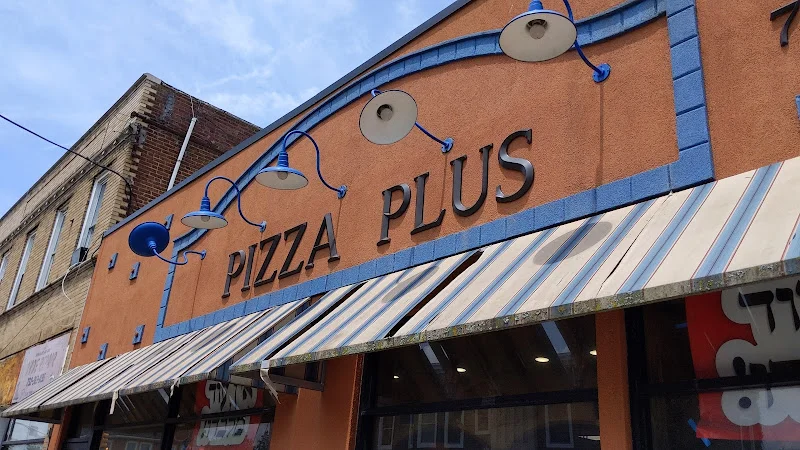 Exterior view of Pizza Plus restaurant with colorful signage