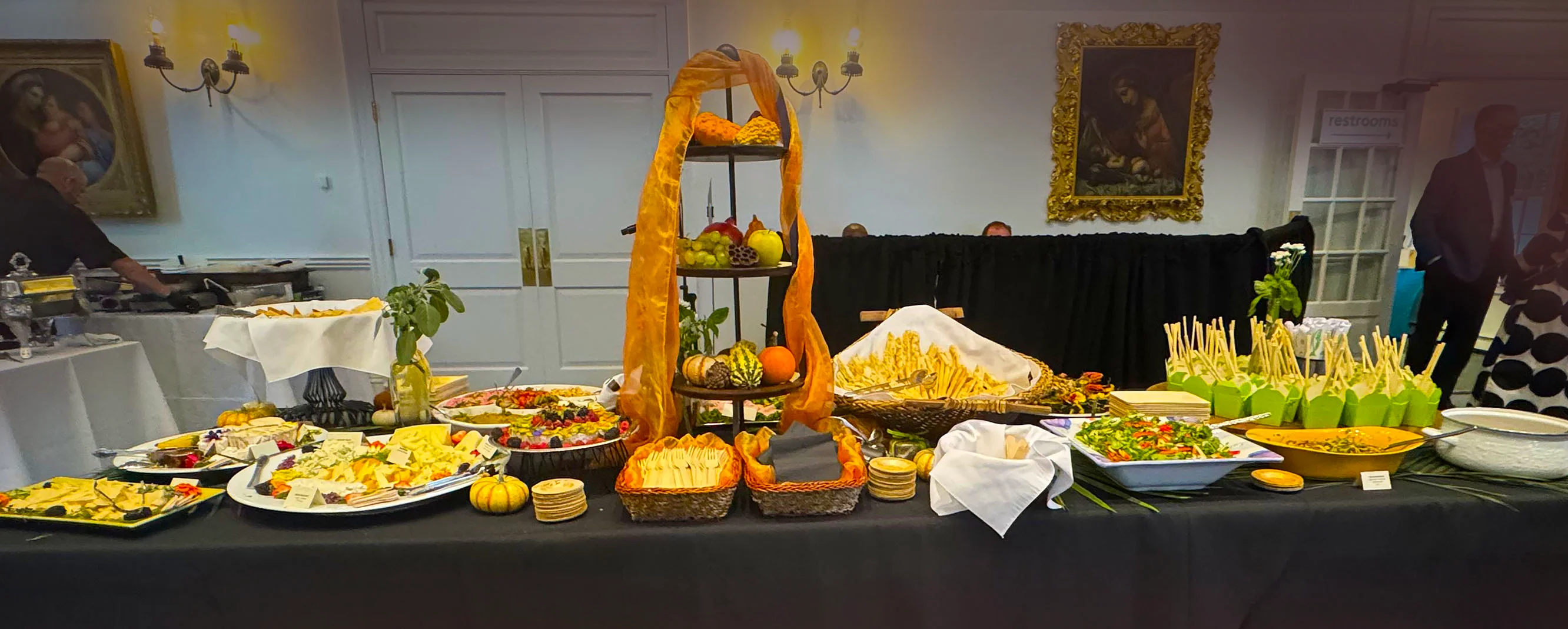 Full service catering spread with a variety of dishes set on a long table at Exit 4 Food Hall in Mount Kisco