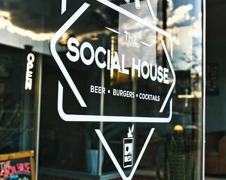 Exterior view of The Social House restaurant with logo and open sign