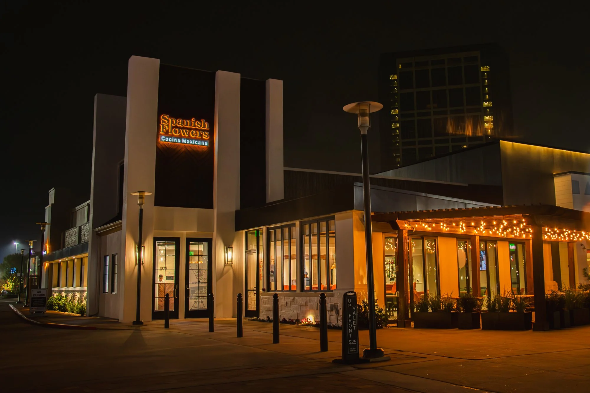 Modern restaurant exterior with warm lighting and inviting ambiance at night