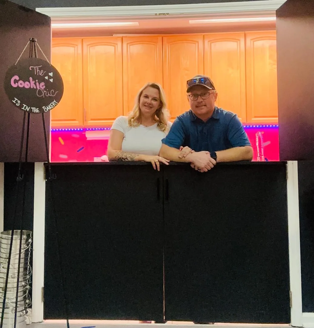 Bakery counter with cheerful owners at The Cookie Chic