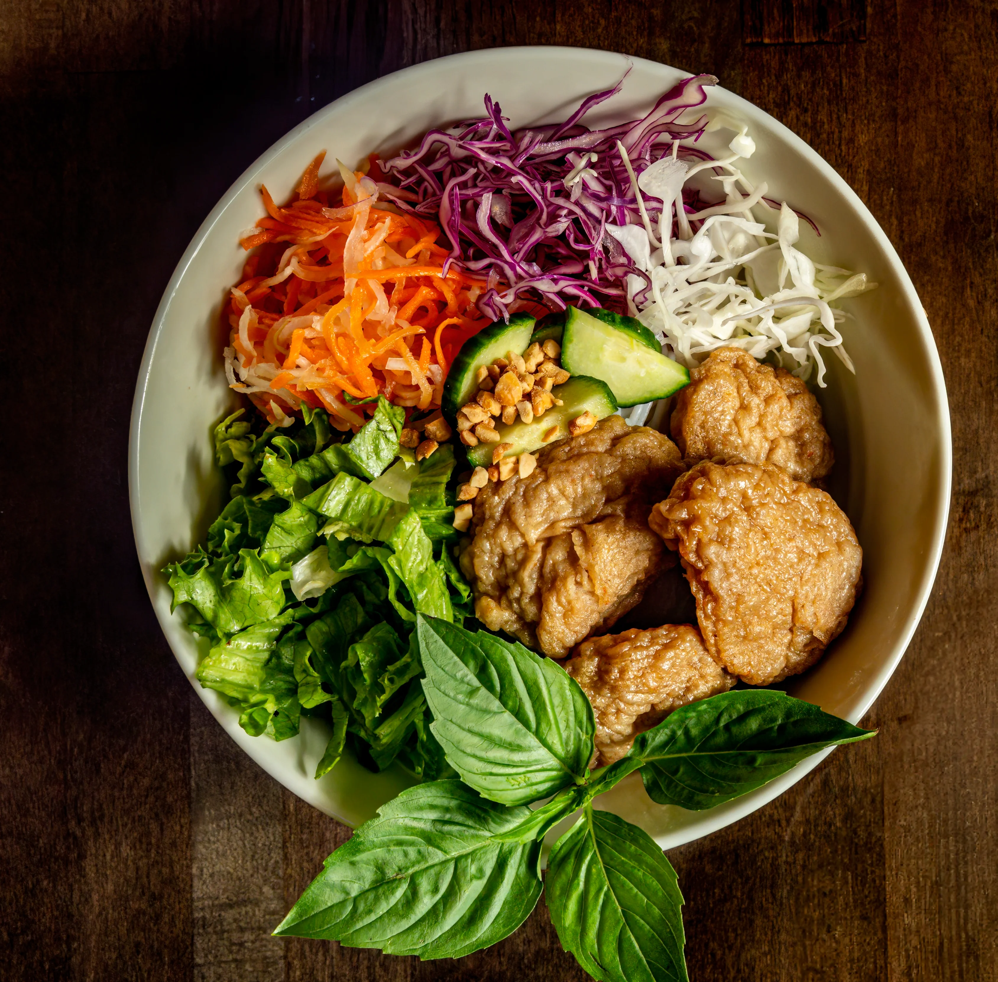 Vietnamese rice bowl with crispy chicken and fresh vegetables
