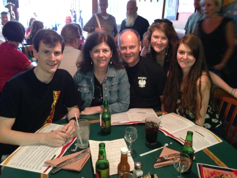 Group of friends enjoying a meal in a lively restaurant setting