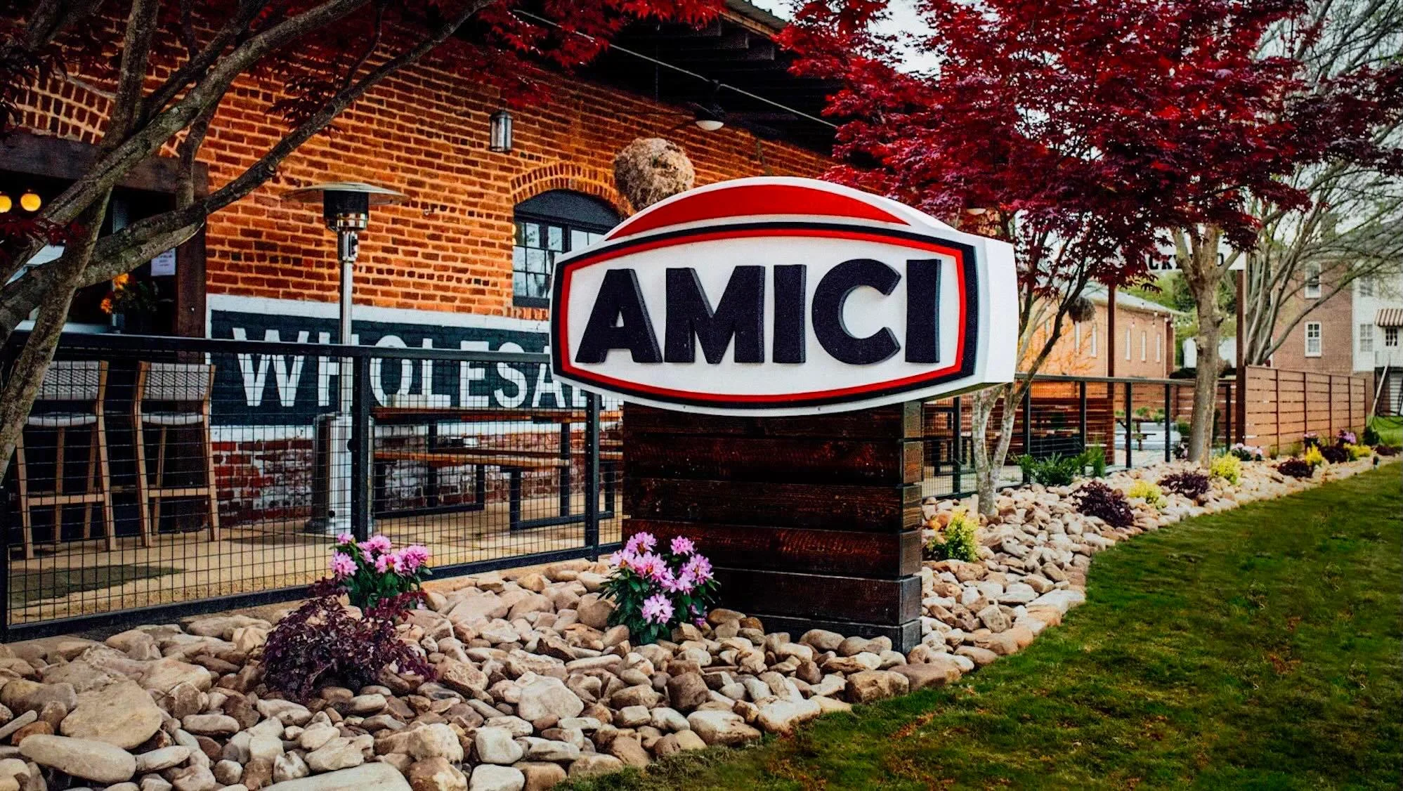 Exterior view of Amici restaurant with vibrant landscaping