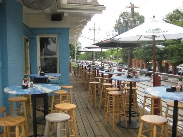 Outdoor dining area with blue tables and umbrellas