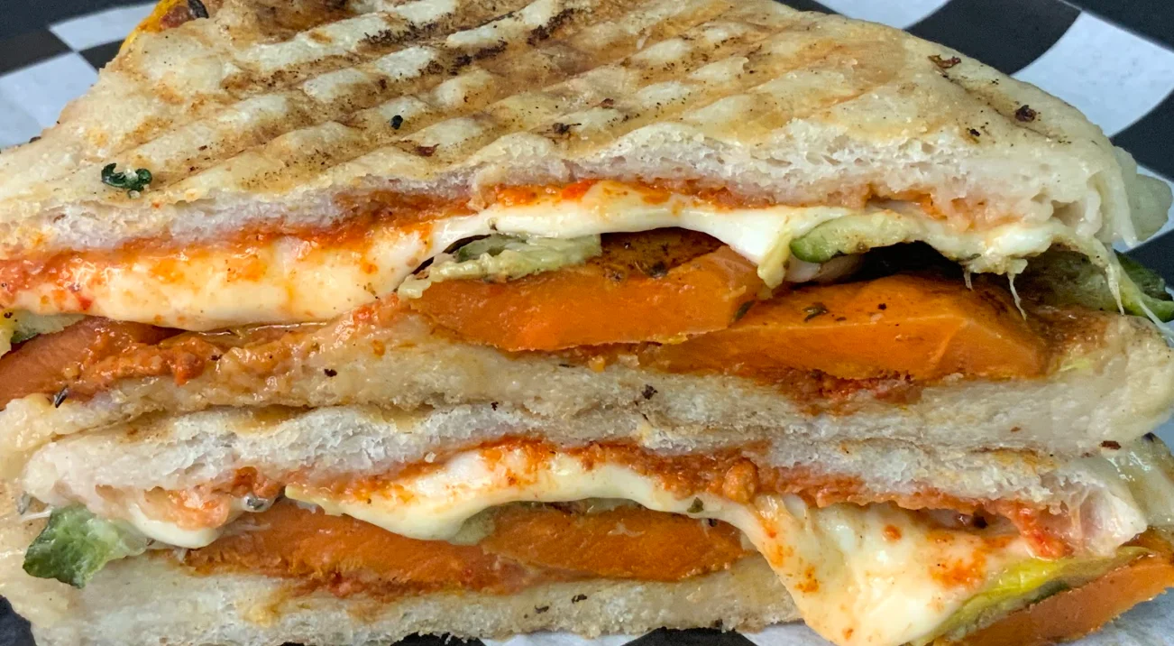 The Gio has roasted zucchini, squash, carrots & mozza- rella with a walnut-red pepper pesto on grilled ciabatta.