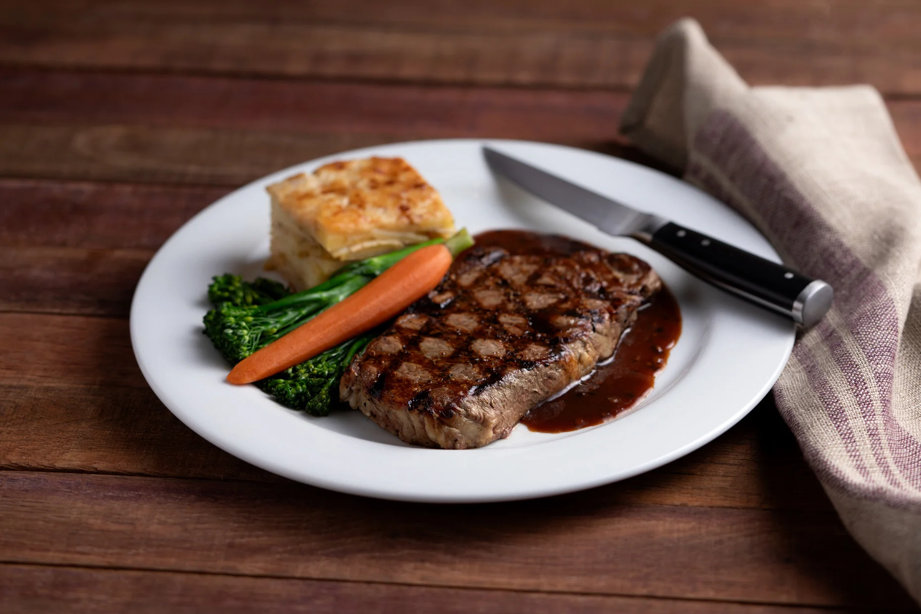 Grilled steak with vegetables and potato gratin