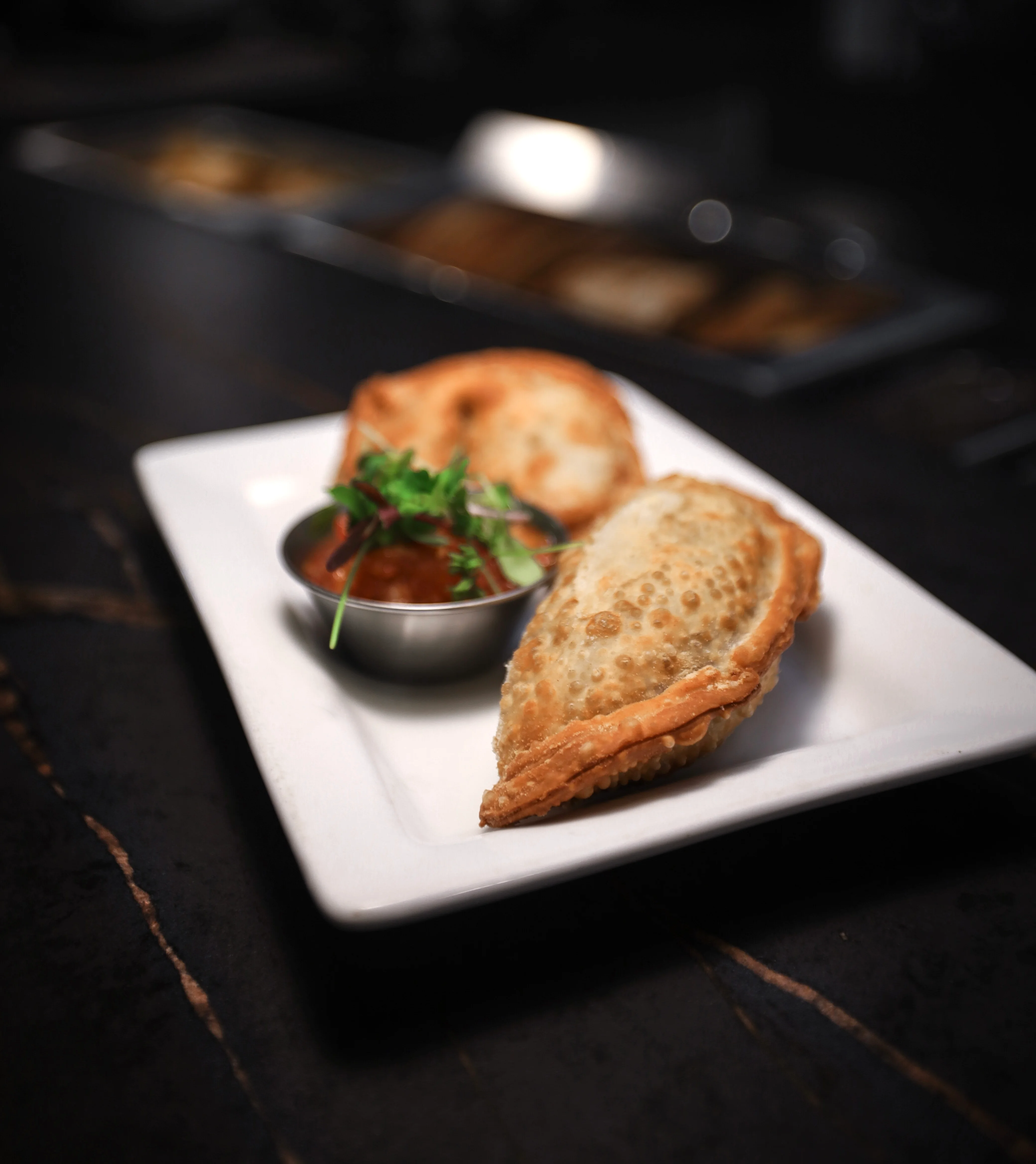 Crispy Indian samosas served with tangy chutney