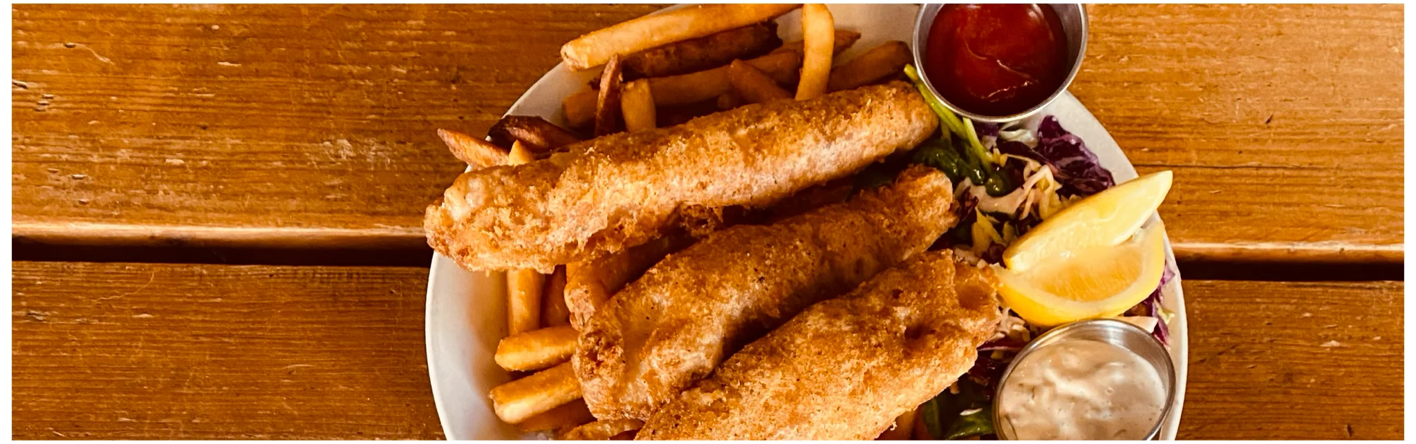 Crispy fish and chips served with lemon and dipping sauces