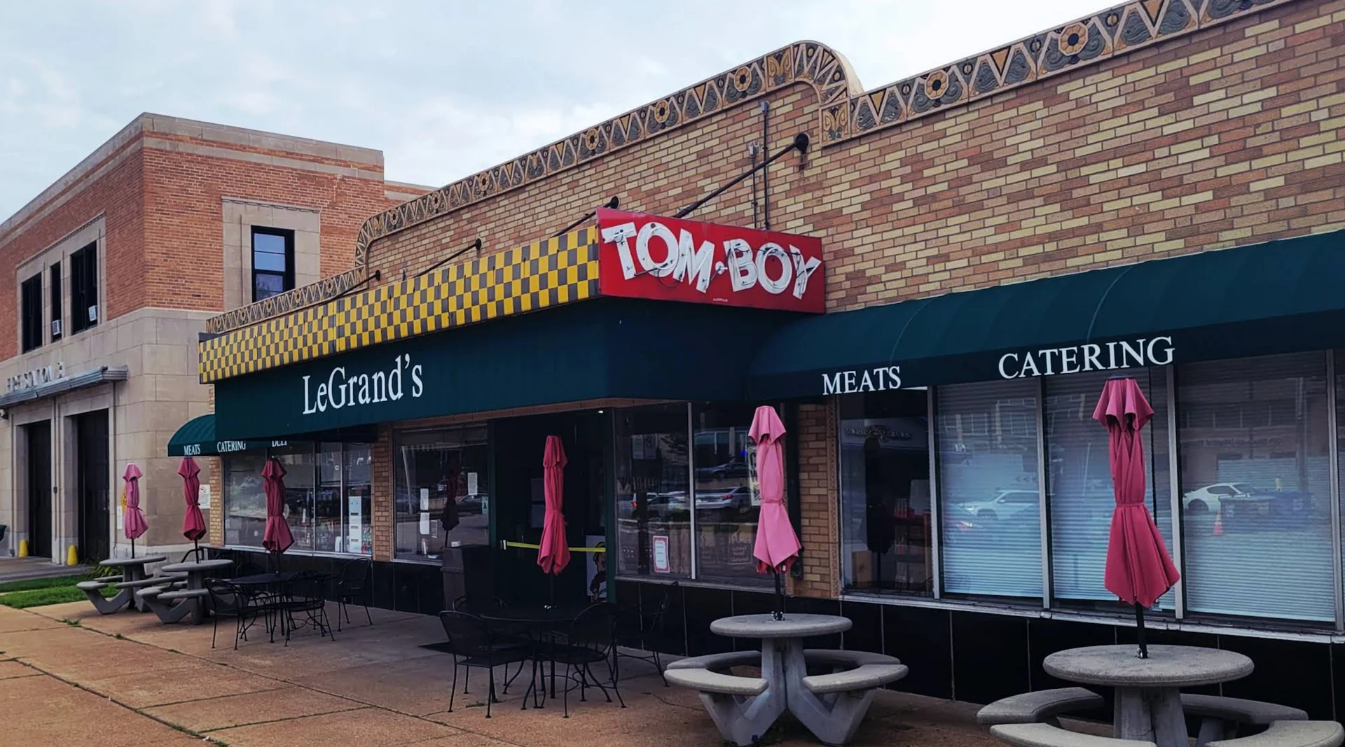 Exterior view of LeGrand's and Tom Boy restaurant with outdoor seating