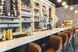 Modern bar counter with stylish seating and wine display