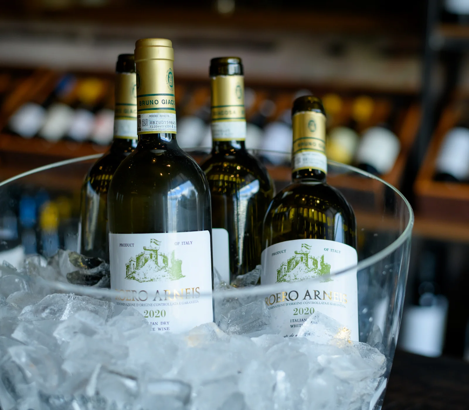 Chilled Italian white wine bottles in ice bucket