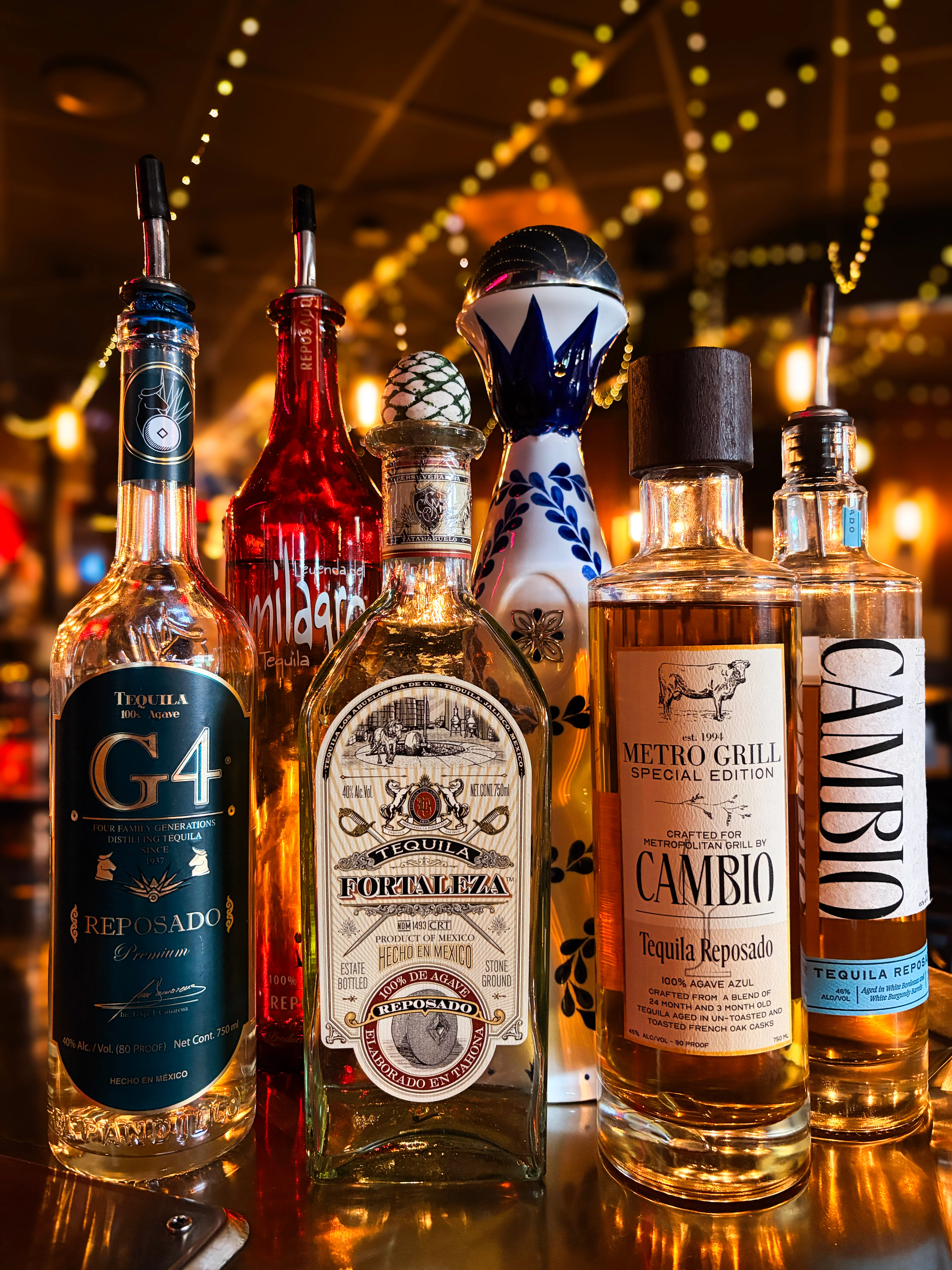 Selection of premium tequila bottles on a bar counter