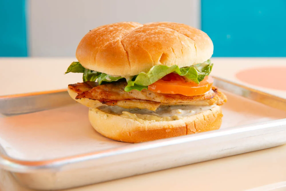 Delicious gourmet burger with fresh toppings on a wooden table