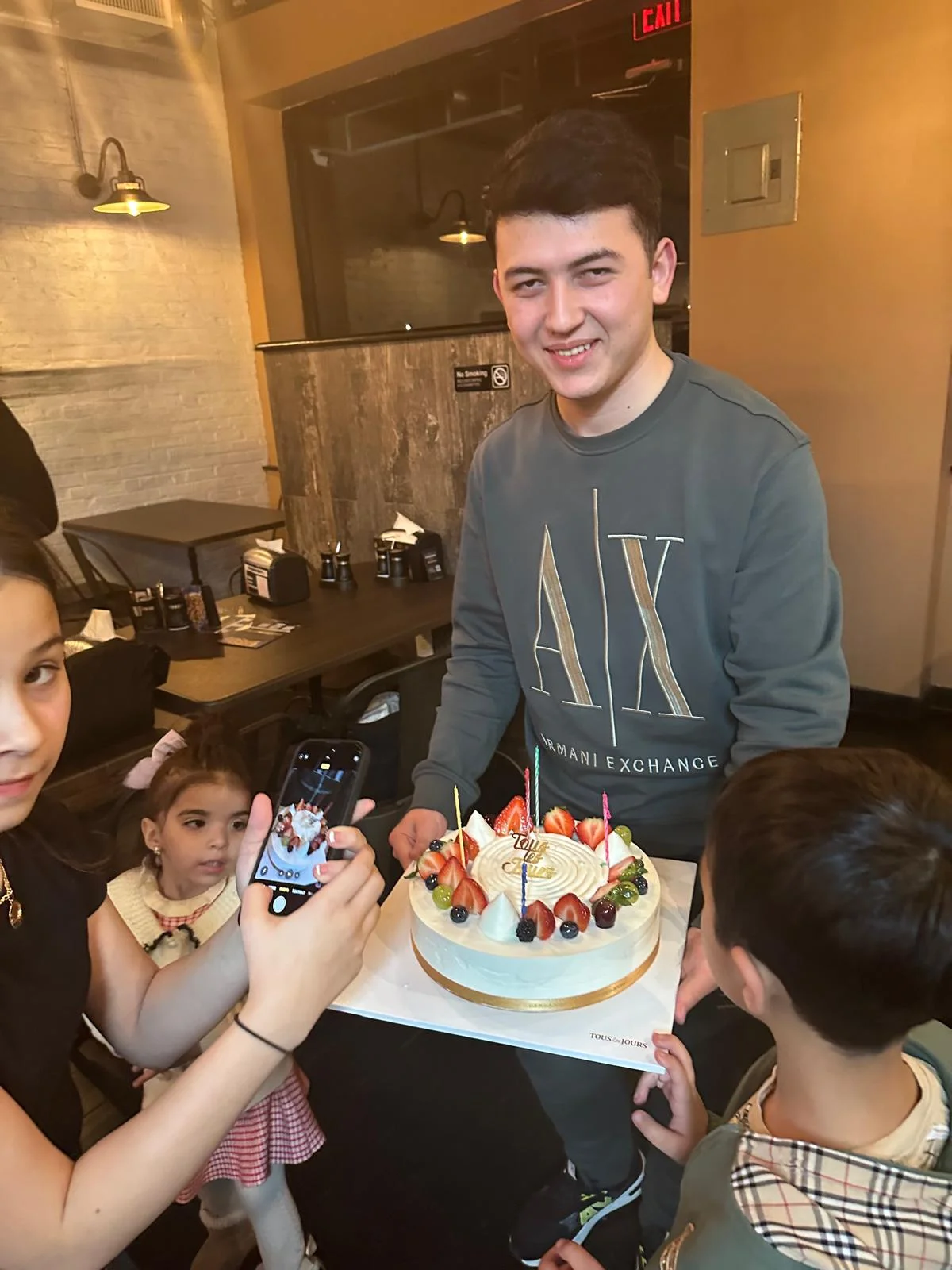 Celebratory birthday cake with fresh fruits and candles