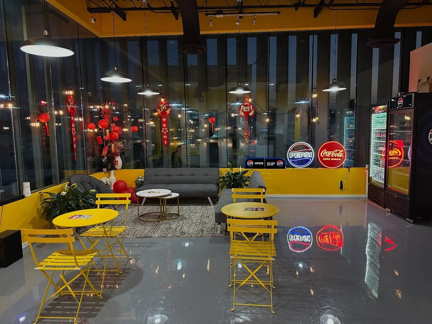 Modern restaurant interior with yellow decor and cozy seating