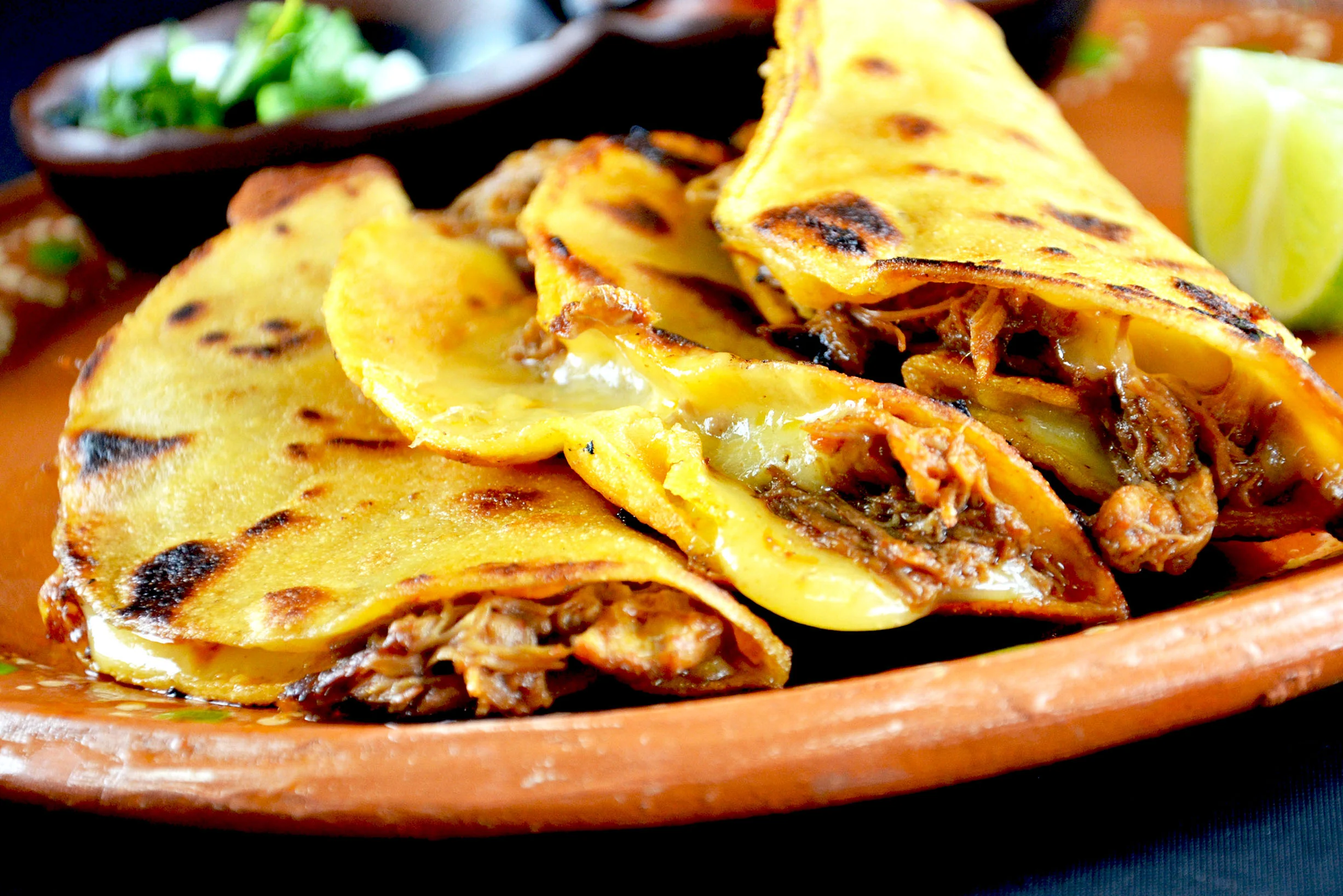 Delicious Mexican quesabirria tacos with melted cheese