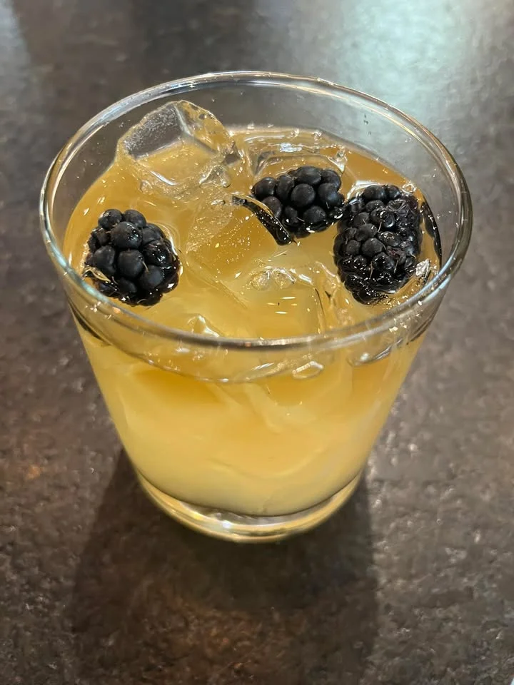 Refreshing cocktail with blackberries and ice