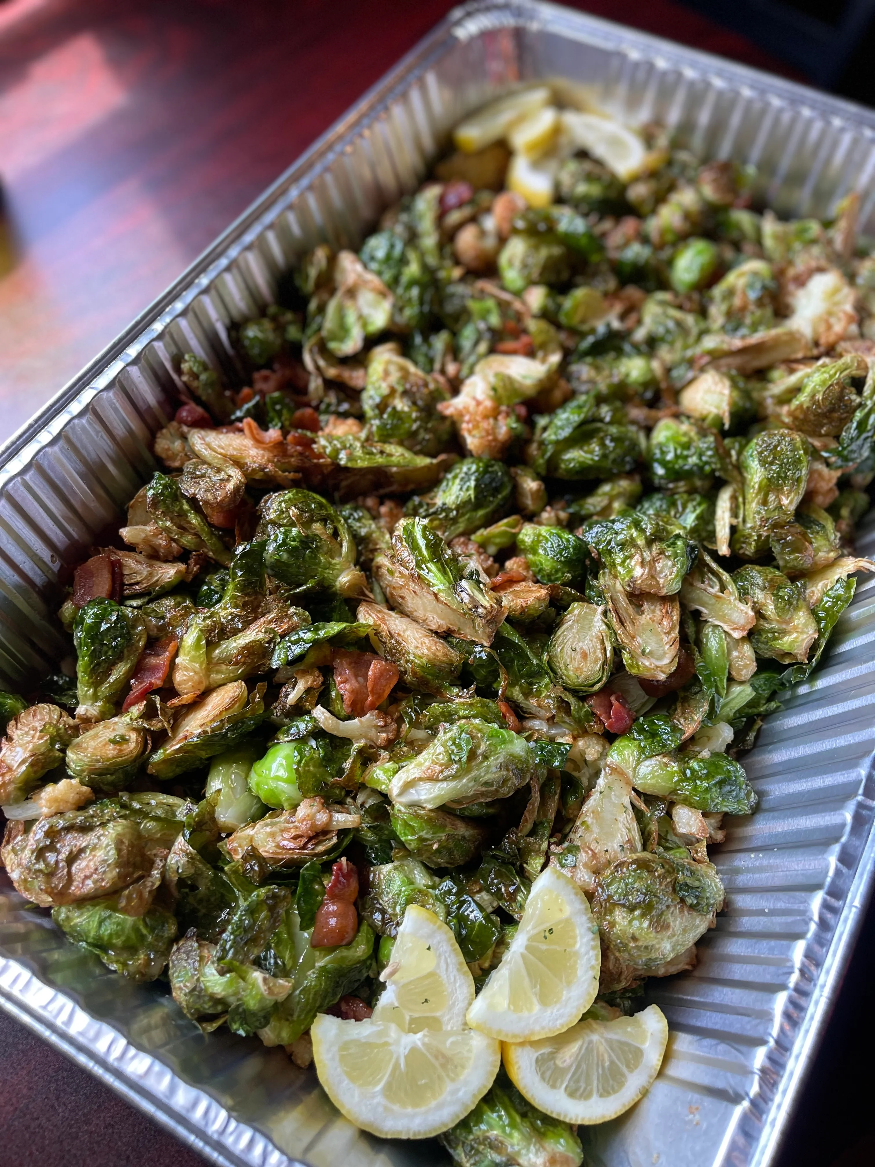 Crispy Brussels sprouts with bacon and lemon garnish