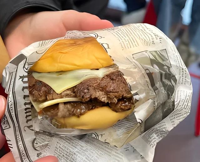 Delicious gourmet burger with fresh toppings on a wooden table