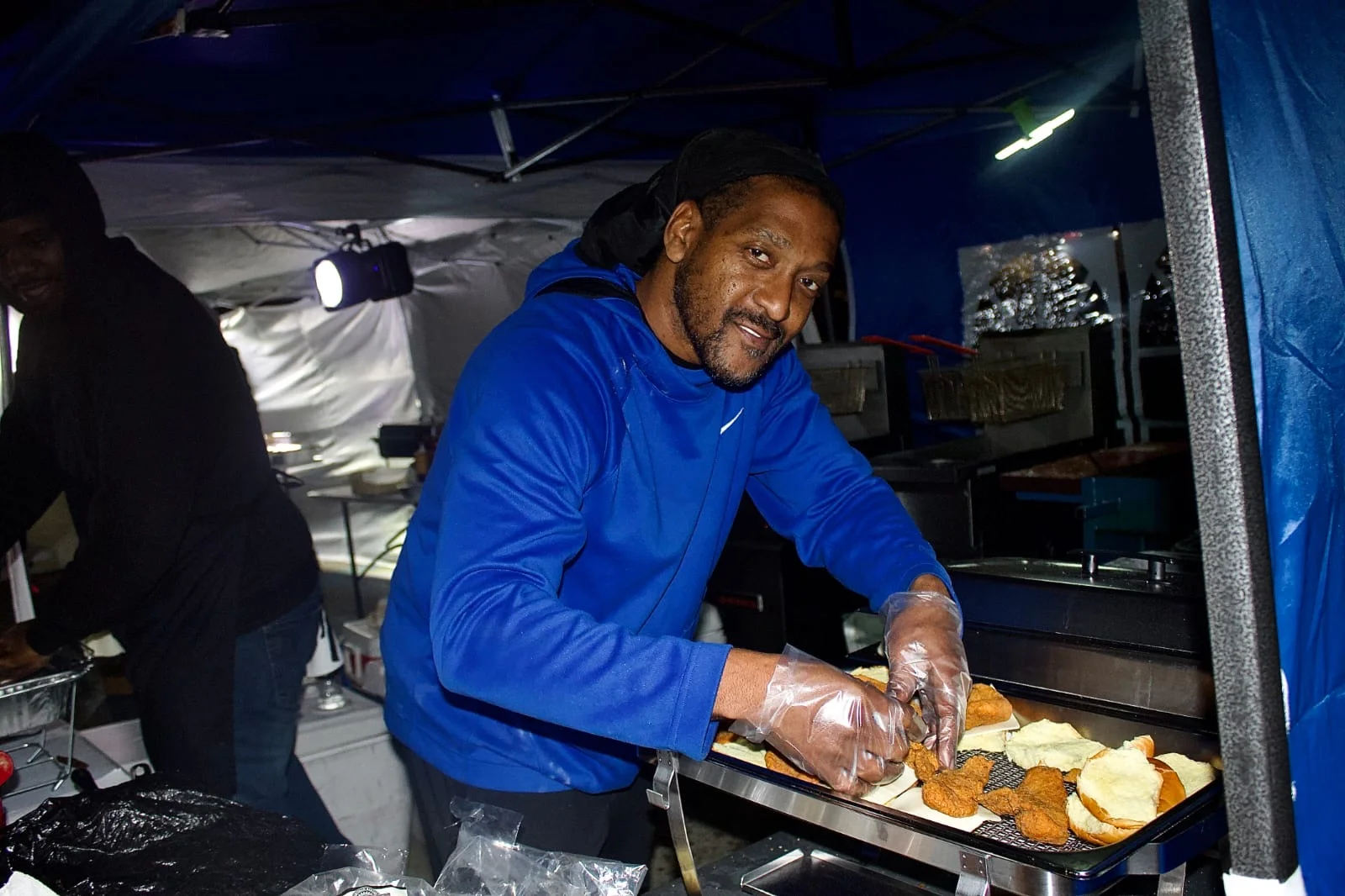 Itean Dozier in his signature blue color, creating enjoyment for customers in the form of food.