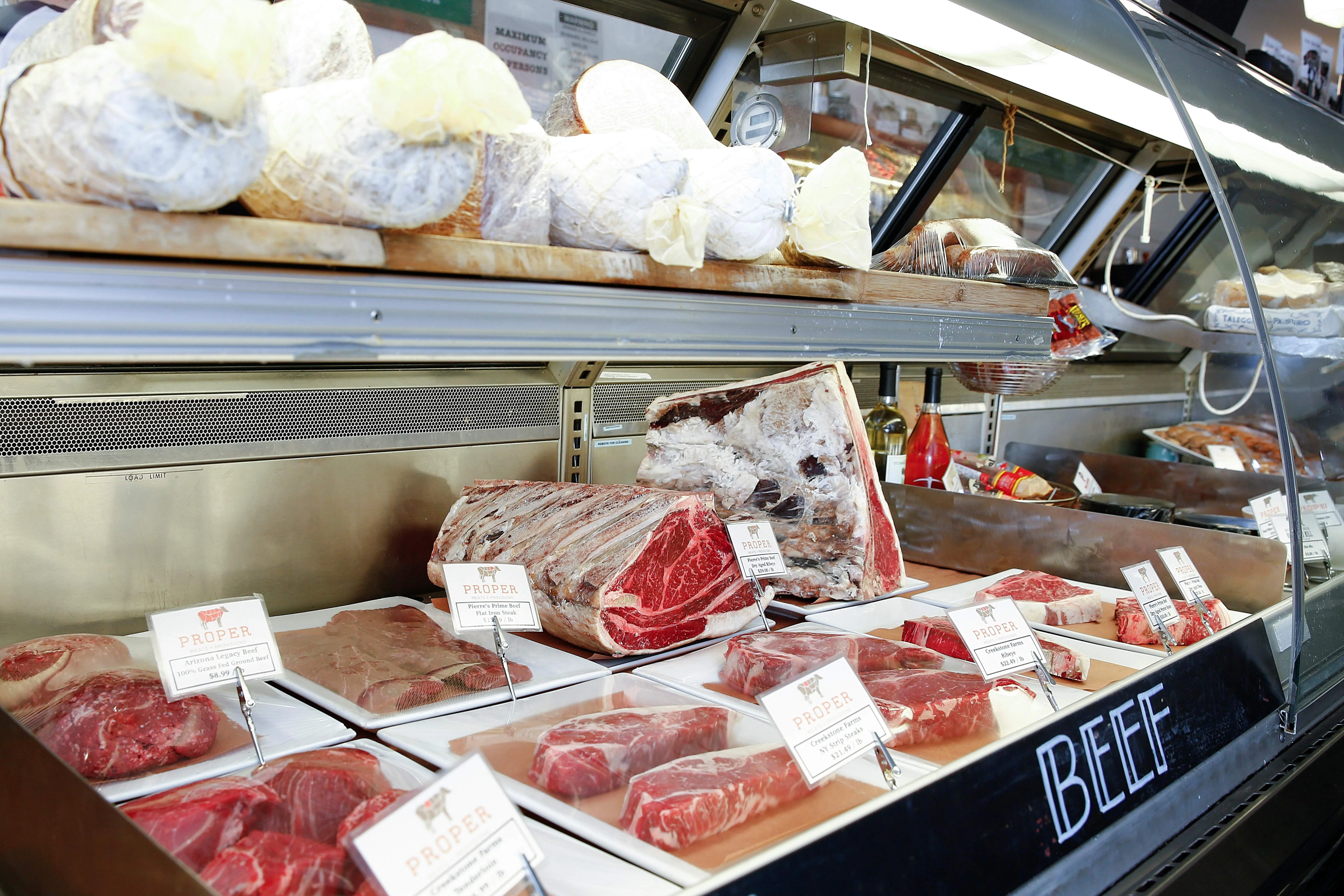 Selection of premium beef cuts in a butcher shop display