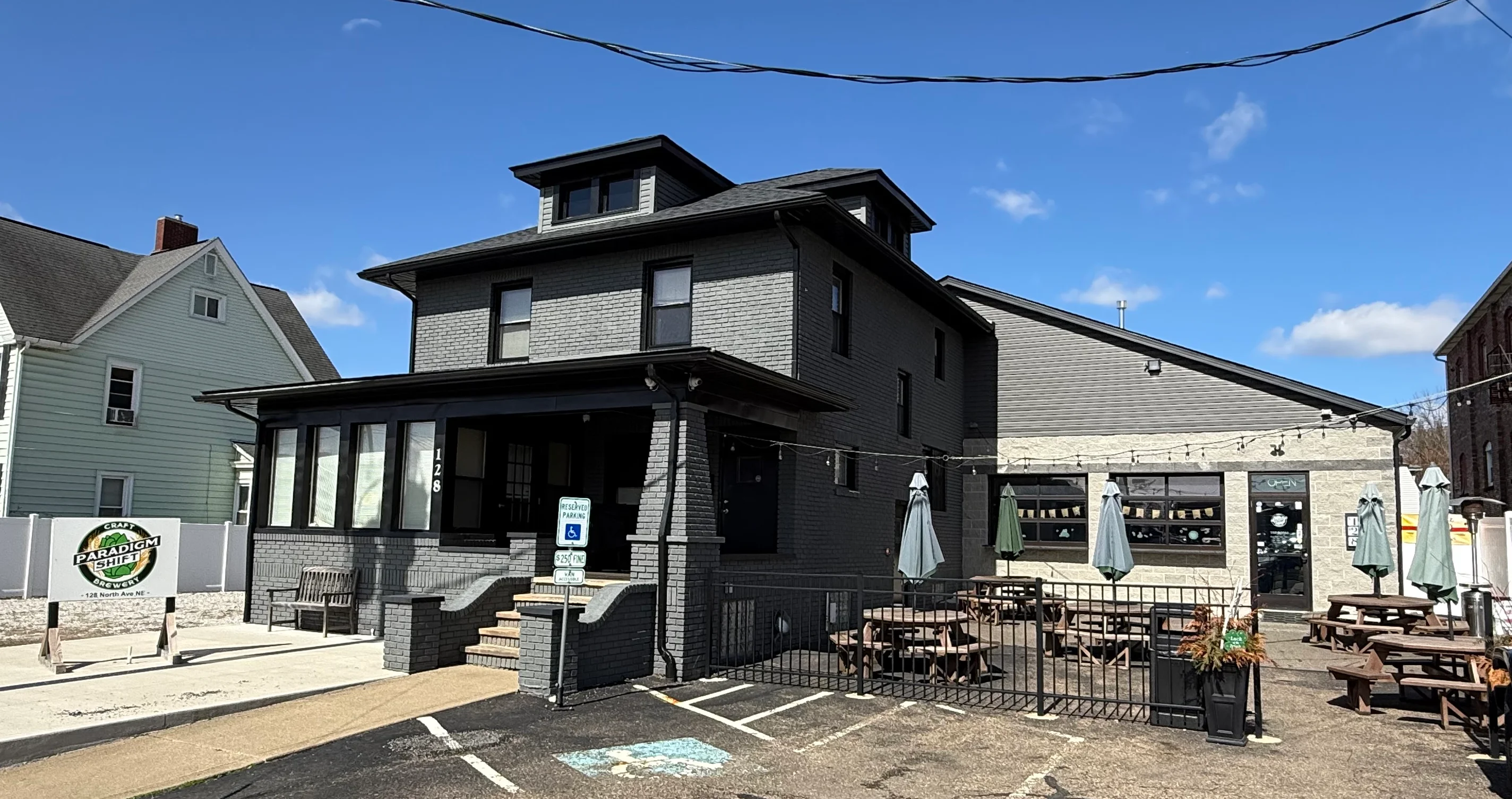 Exterior view of a modern restaurant with large windows and outdoor seating.