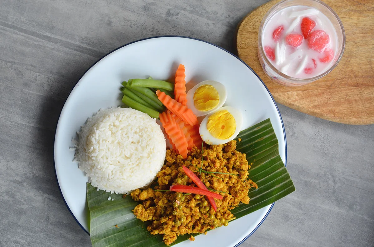 Indonesian nasi goreng with vegetables and boiled eggs