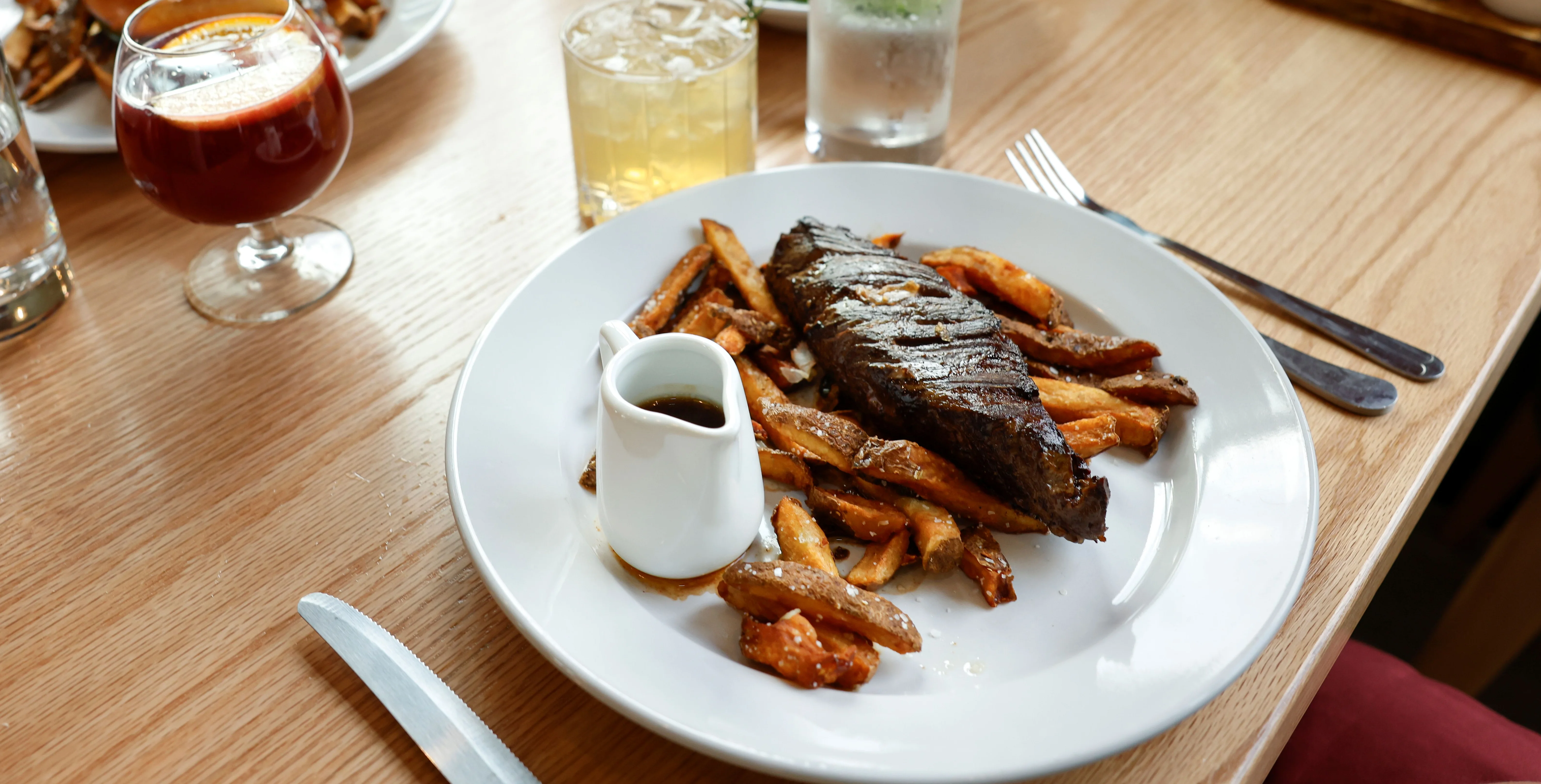 Grilled steak frites served in a cozy restaurant setting