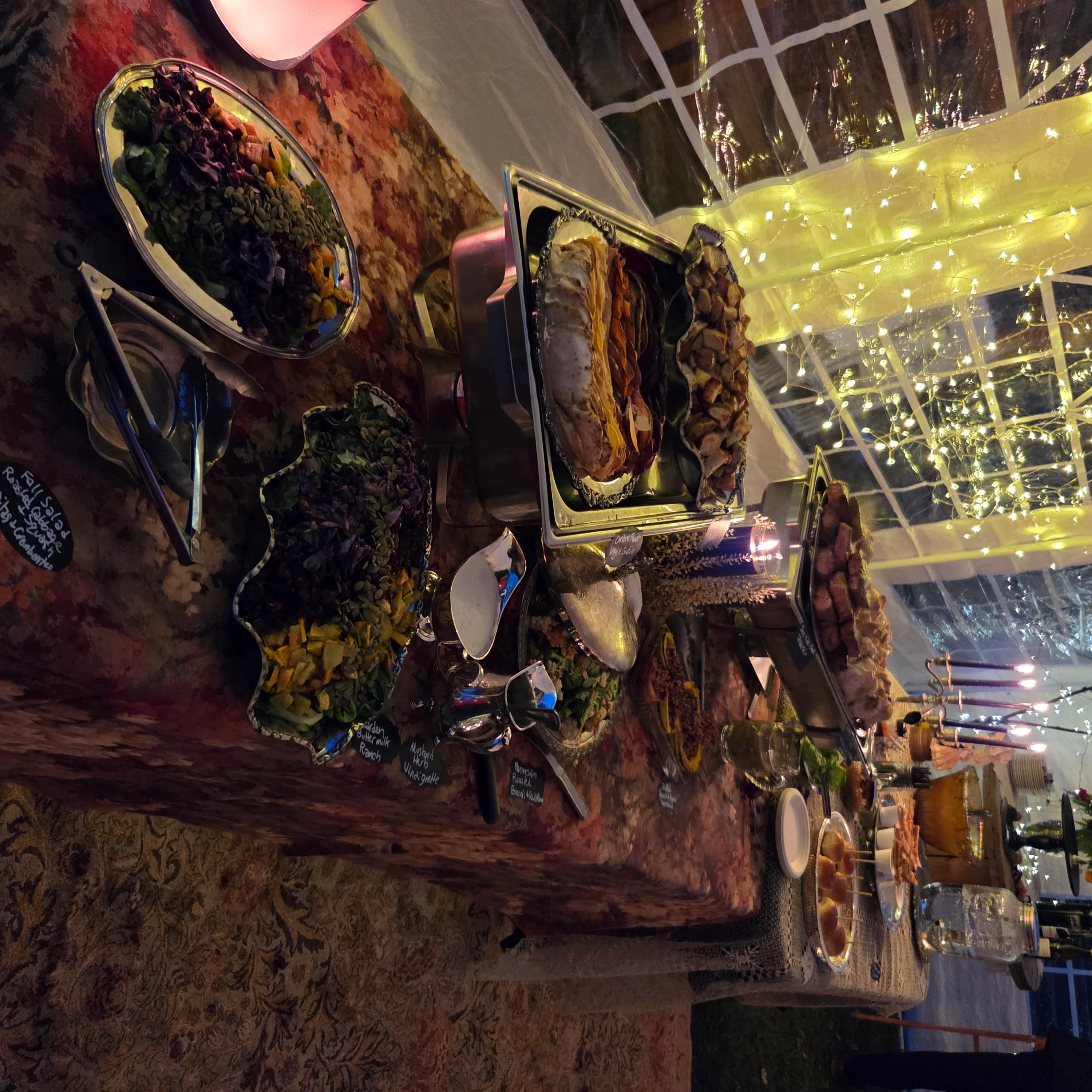 Elegant buffet table with assorted dishes and festive lighting