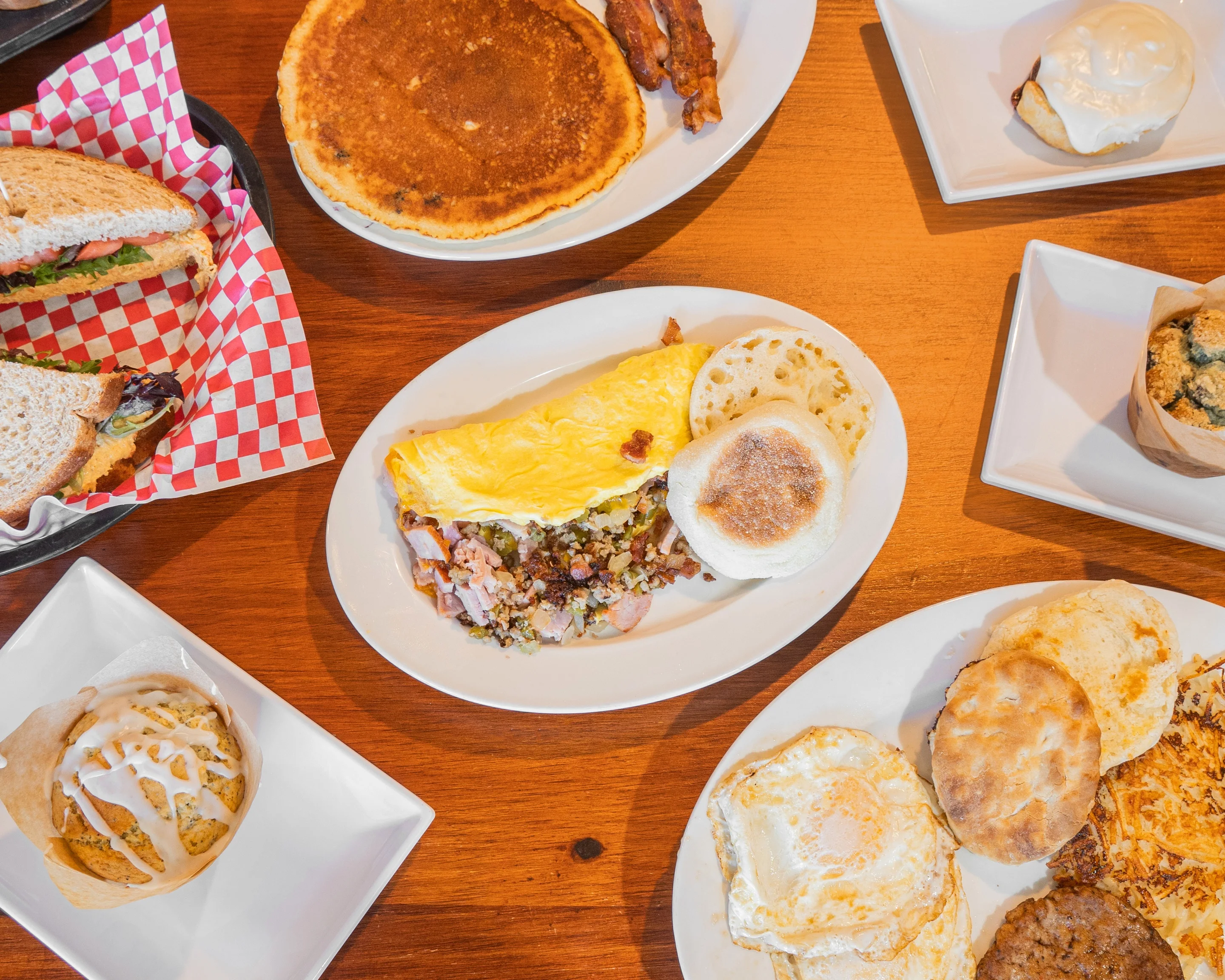 A vibrant spread of various delicious dishes on a wooden table.